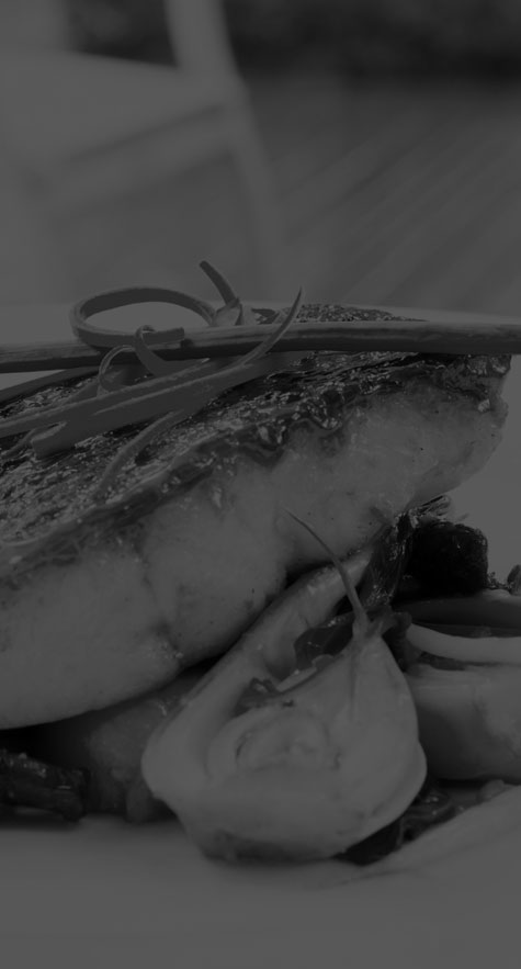 Restaurant seafood dinner with garnish and vegetables (grayscale)